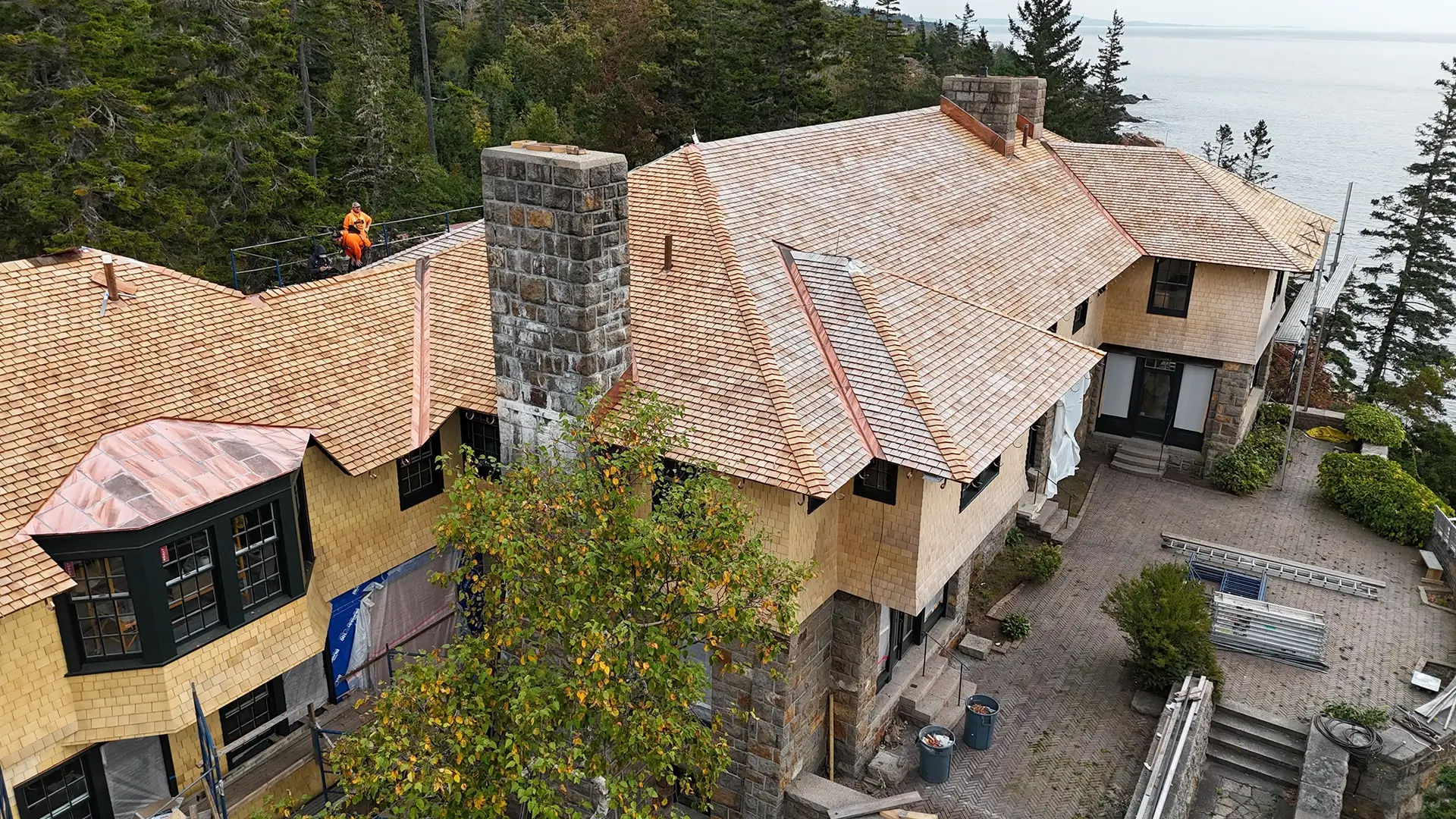 Mansion roof and siding aerial back view.