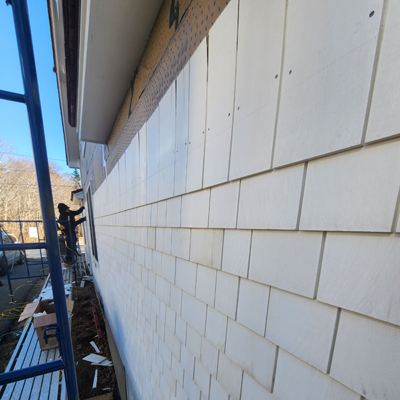 House under construction with white siding. House under construction with white siding.